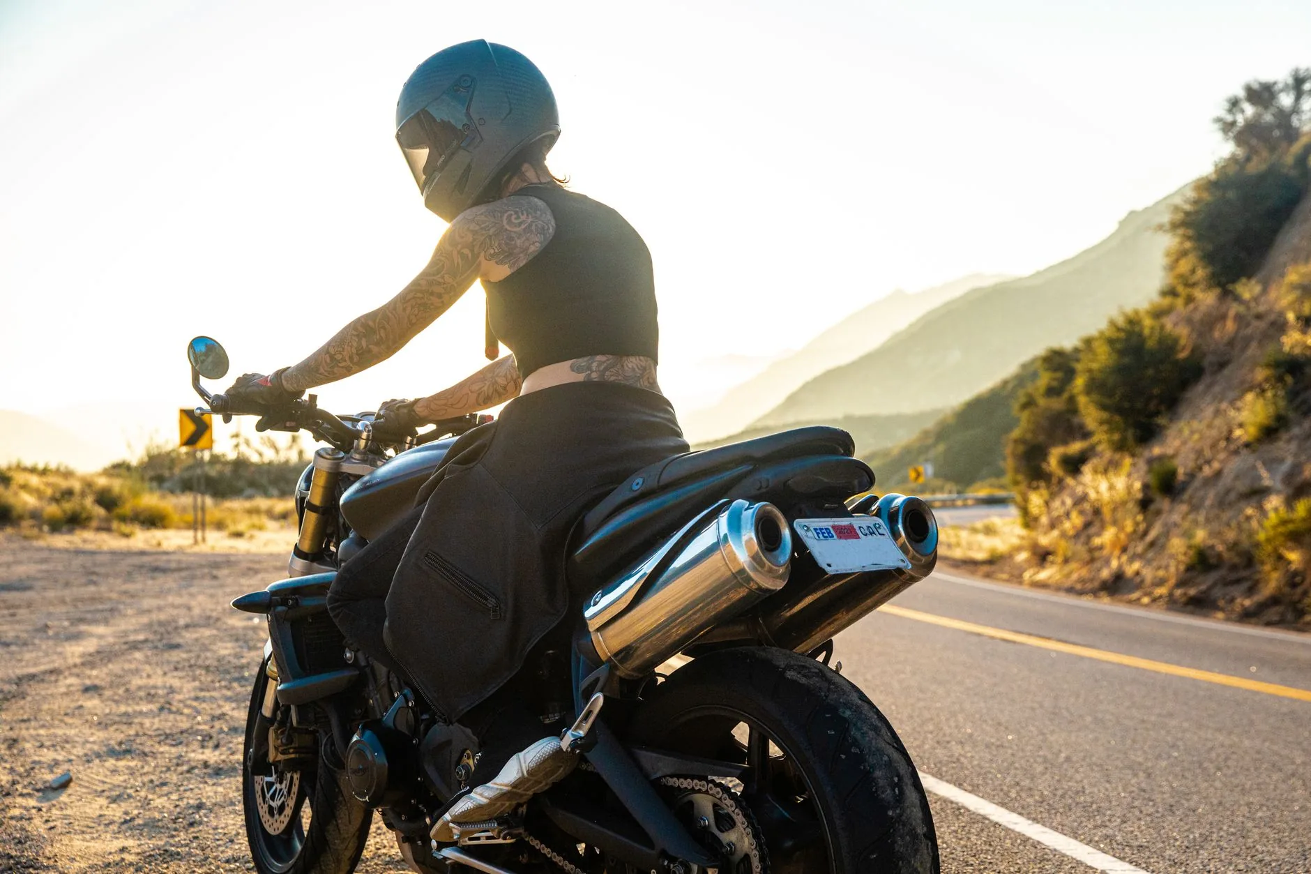 A woman on a C90 adventure bike, exploring dusty trails under soft, diffused light.