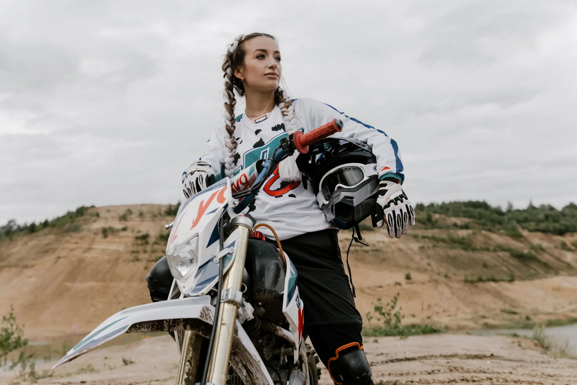 Motorcycle gloves, black and gray, designed for women's adventure, shown in soft, muted light.