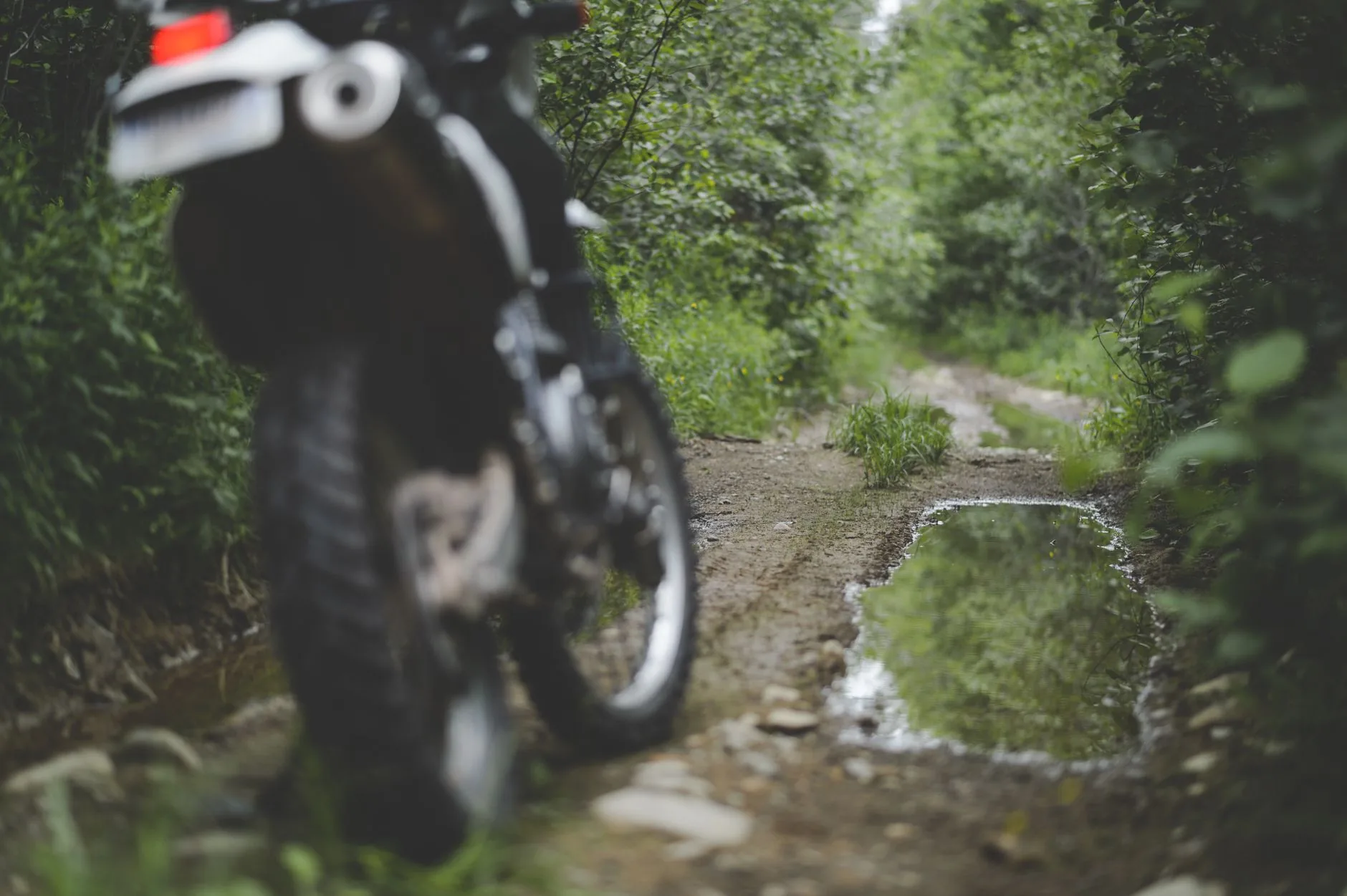 A woman's adventure motorcycle gear shop displaying essential upgrades under soft diffused light.